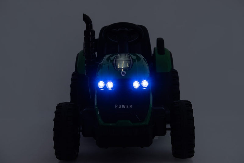 The tractor's blue LED headlights glowing in low light