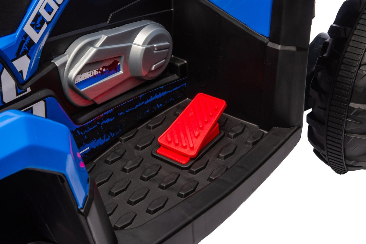 The red foot pedal on the ATV's textured footrest