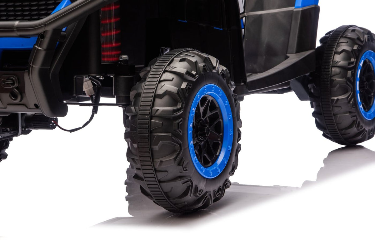 Close-up of a tread wheel with blue rim and a red spring shock