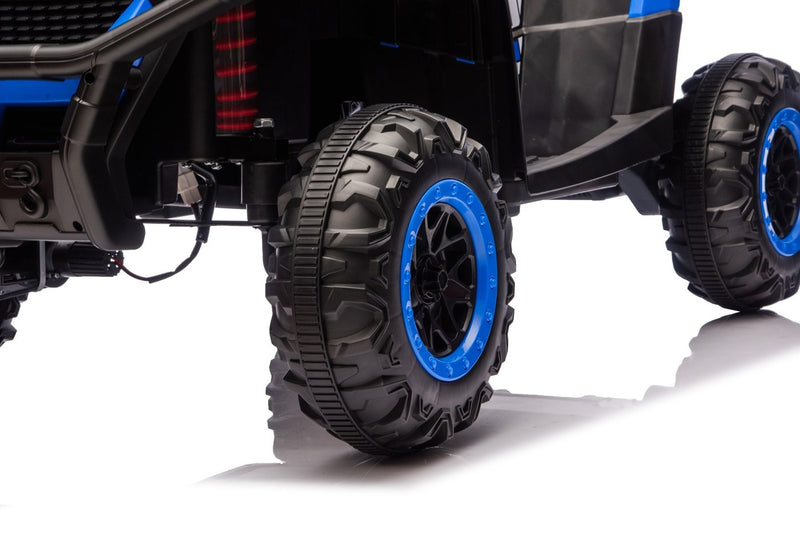 Close-up of a tread wheel with blue rim and a red spring shock