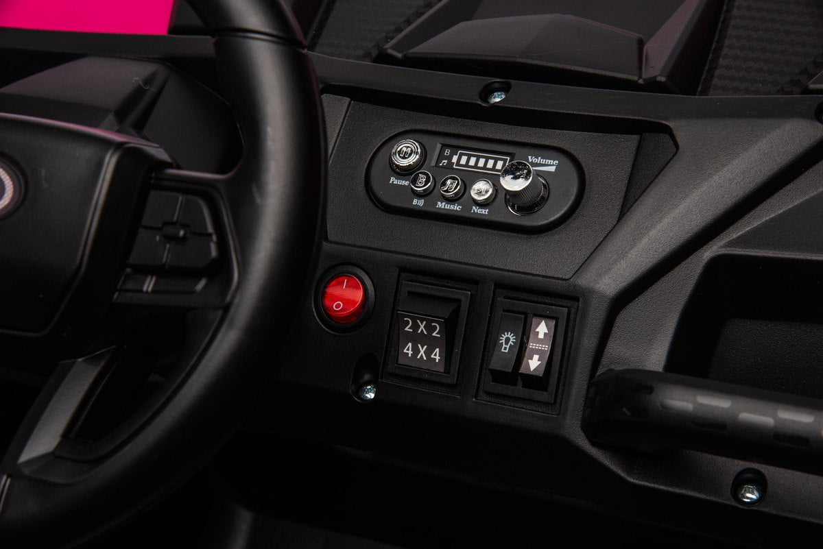 Dashboard with the red start button, 2x2 / 4x4 switch and forward / reverse switch beside the steering wheel