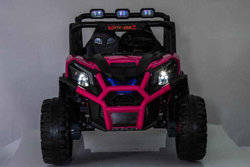 The pink UTV with its LED headlights and three roof lights switched on in a dark room