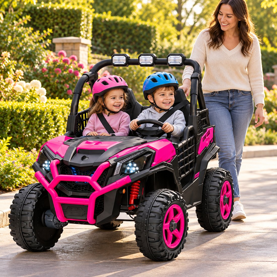 A girl and a boy in helmets ride side by side in the pink UTV while their mom walks alongside