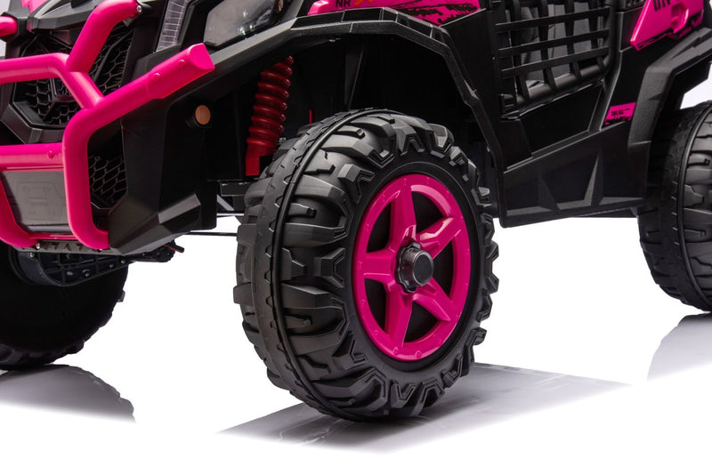 Close-up of a pink wheel and red spring shock