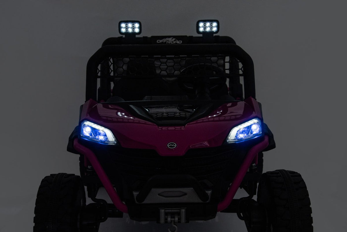 The rose UTV at night with its LED headlights and two roof spotlights switched on