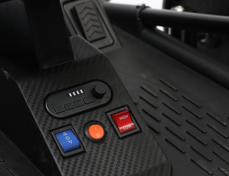The control panel with battery display, music buttons, volume knob, forward / reverse switch, start button and high / low switch