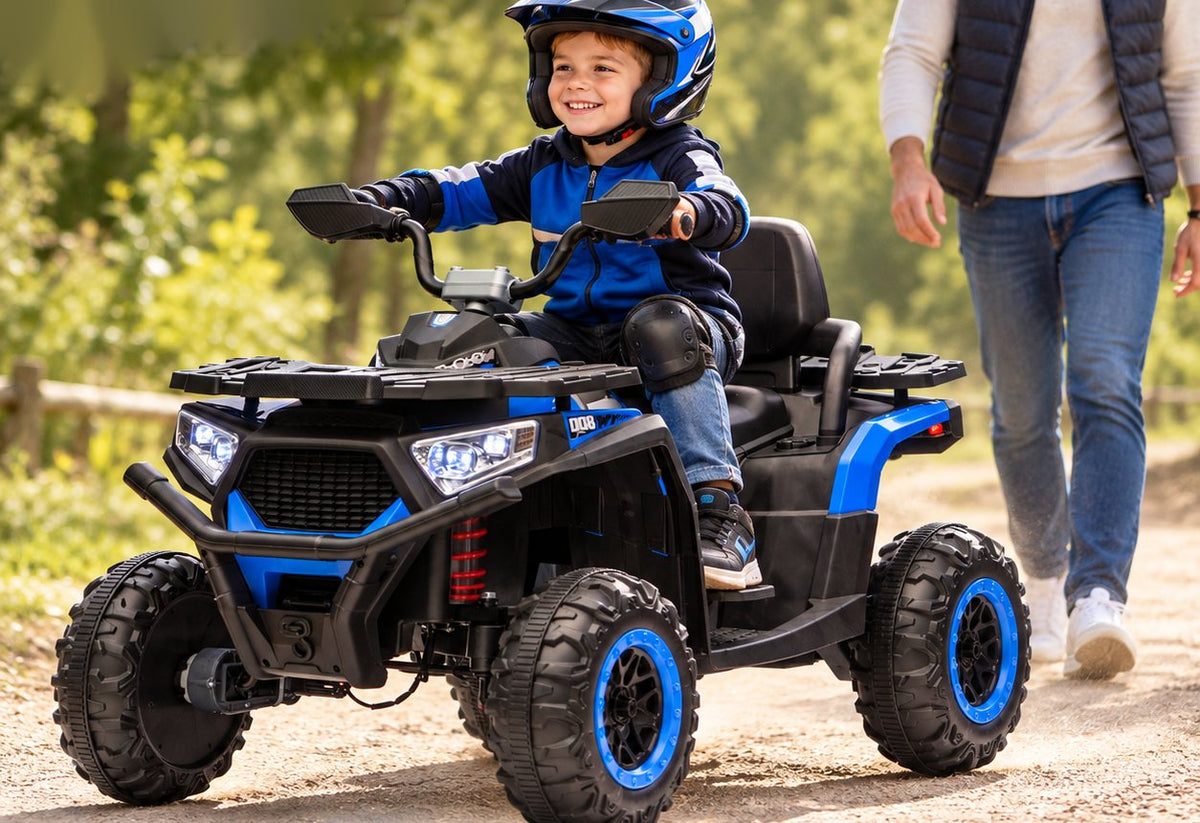 A smiling child in a helmet and knee pads rides the blue ATV down a dirt path as a parent walks behind