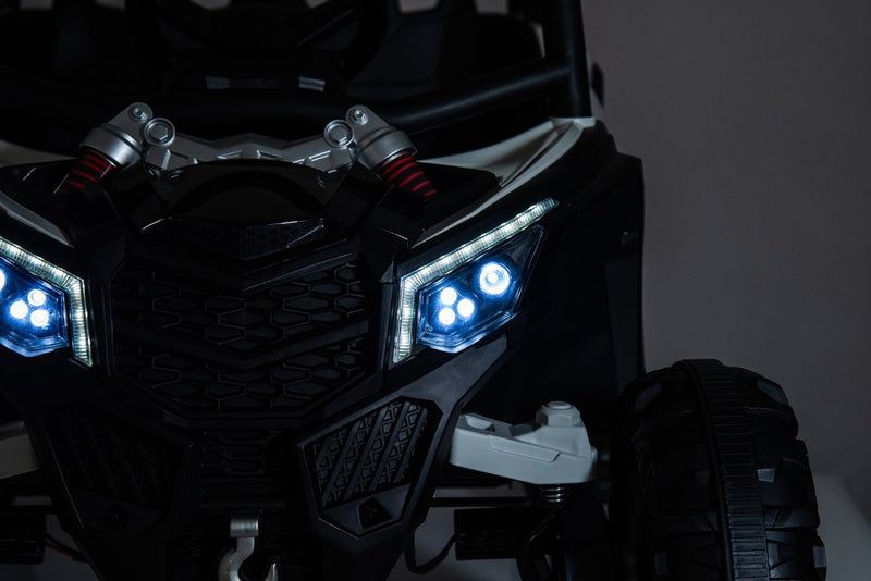 The LED headlights glowing on the front grille