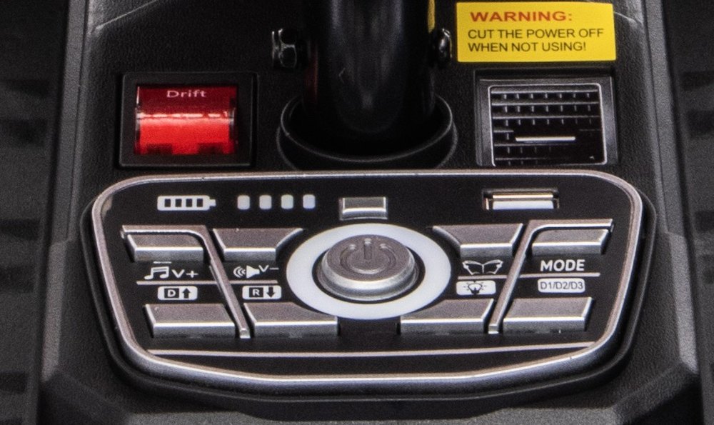 The center control panel with the red Drift switch, battery display, start button, music and mode buttons